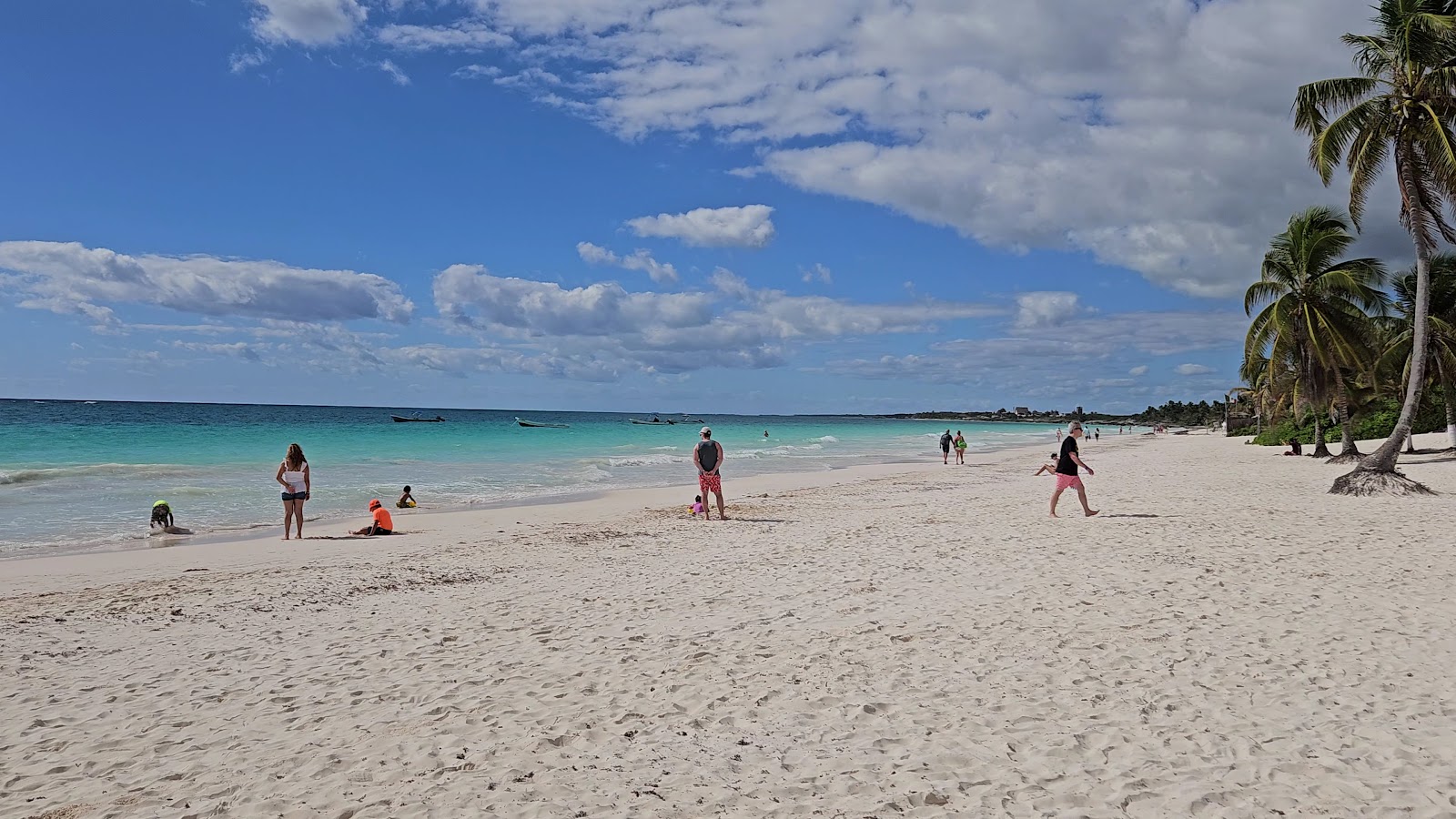 Swimmers walking into the turquoise Caribbean Sea
