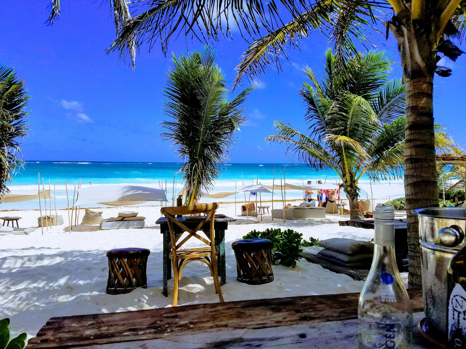 Table set on the beach under palm trees