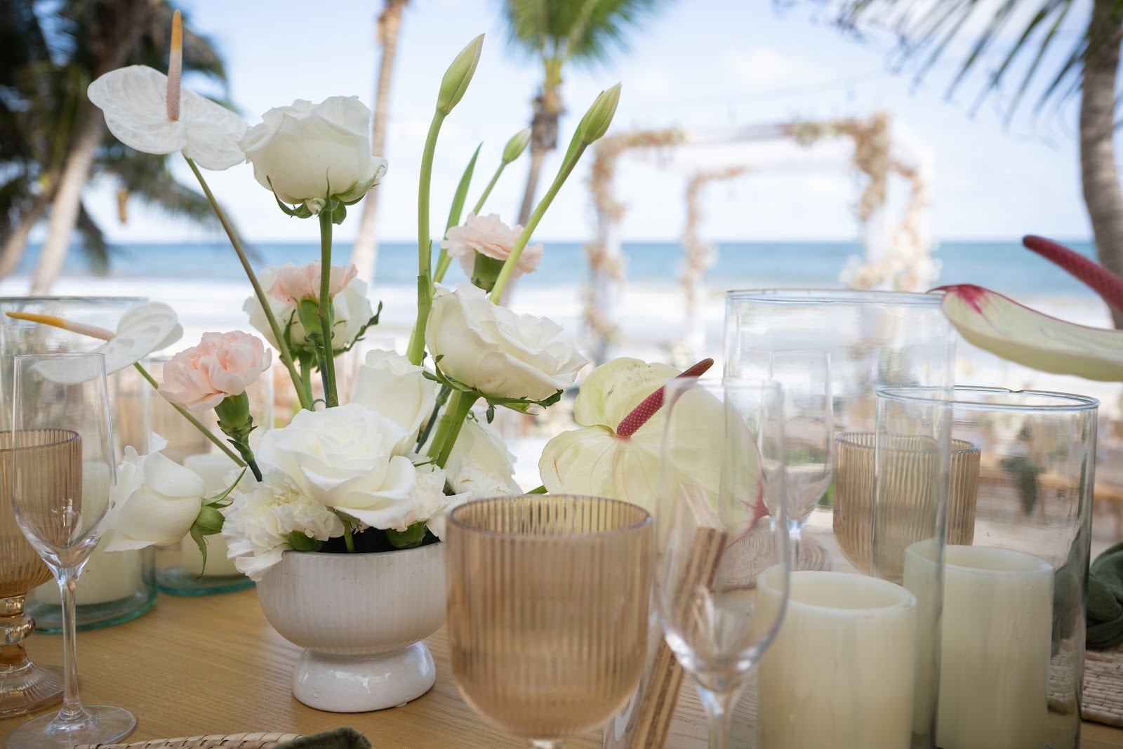 Table set with white flowers and candles by the sea