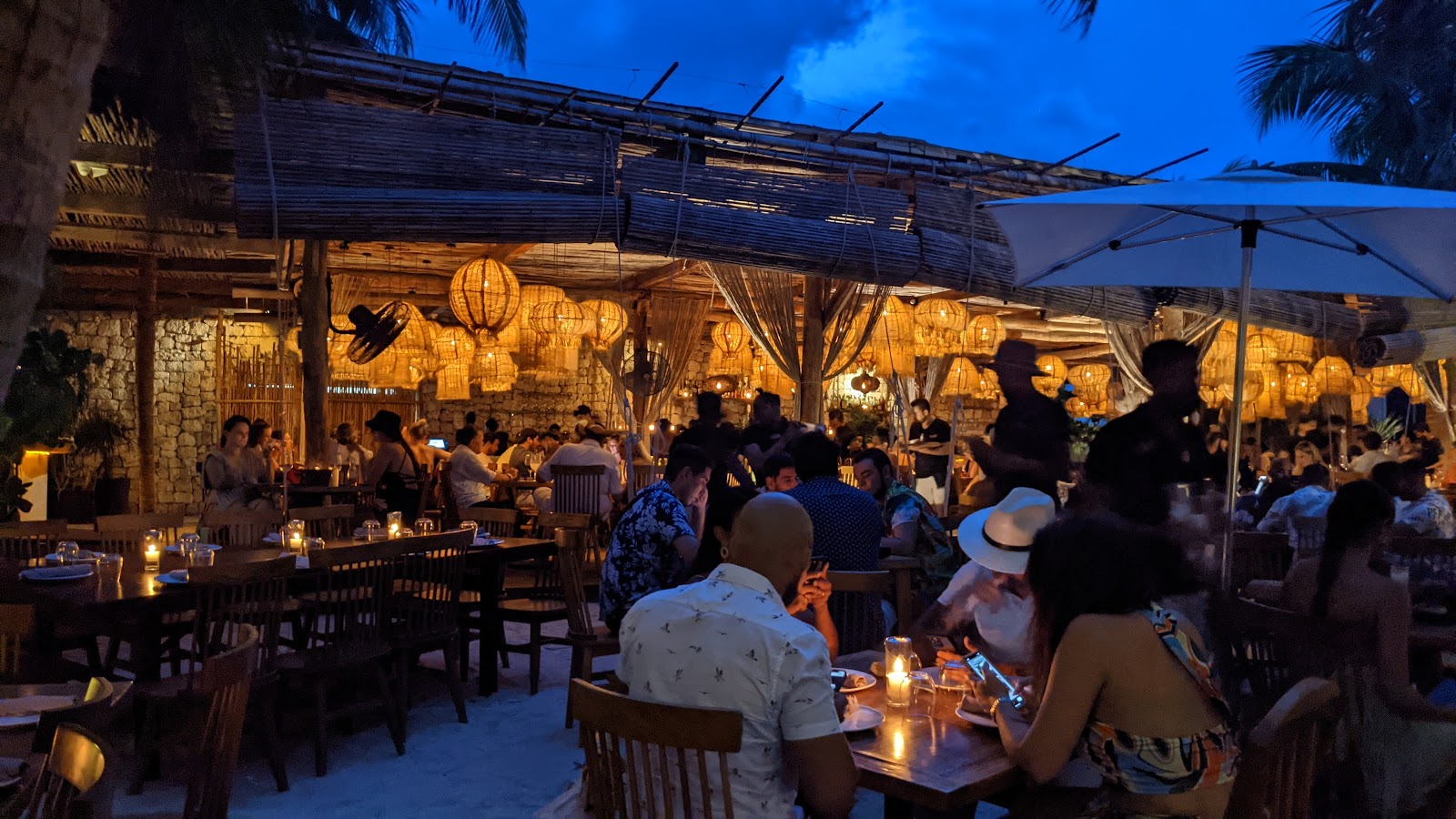 Taboo Tulum packed with guests at night under warm lighting