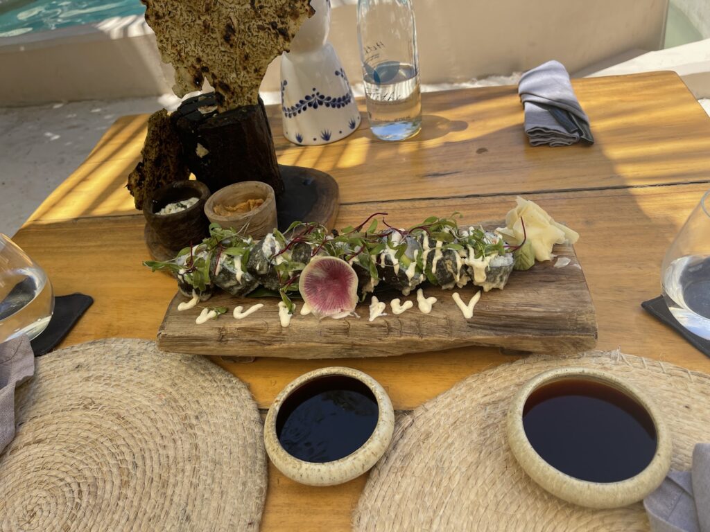 Sushi board and dipping sauces served at a Tantra Beach Club table