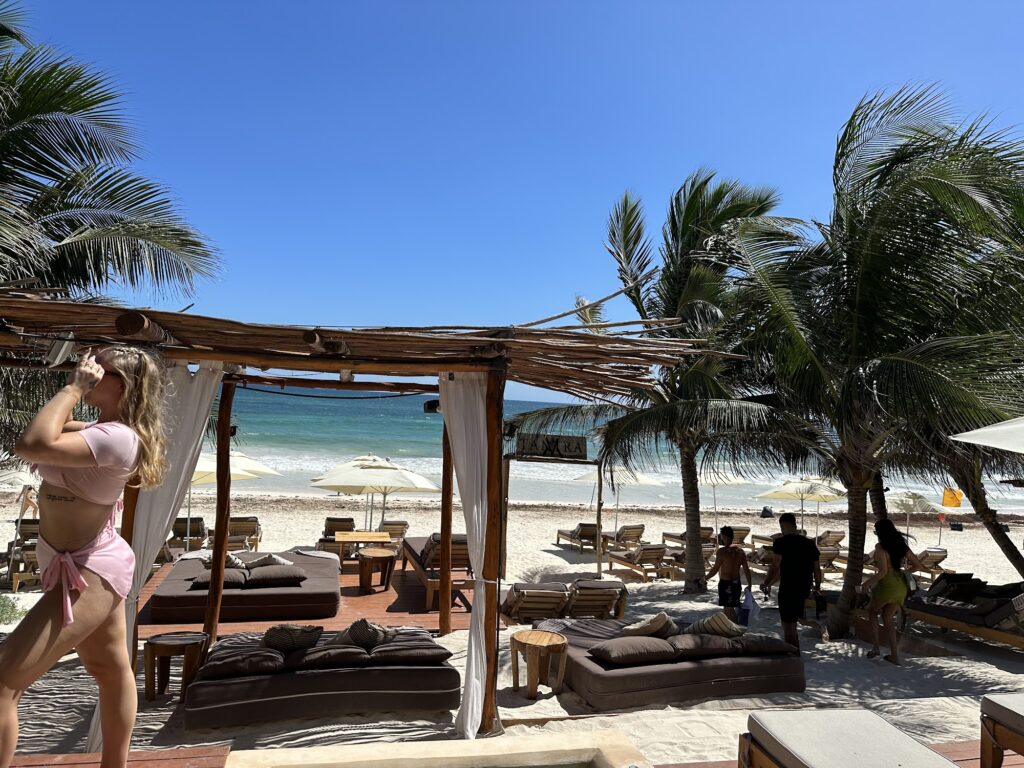 Beachfront cabanas and daybeds on the sand at Tantra Tulum
