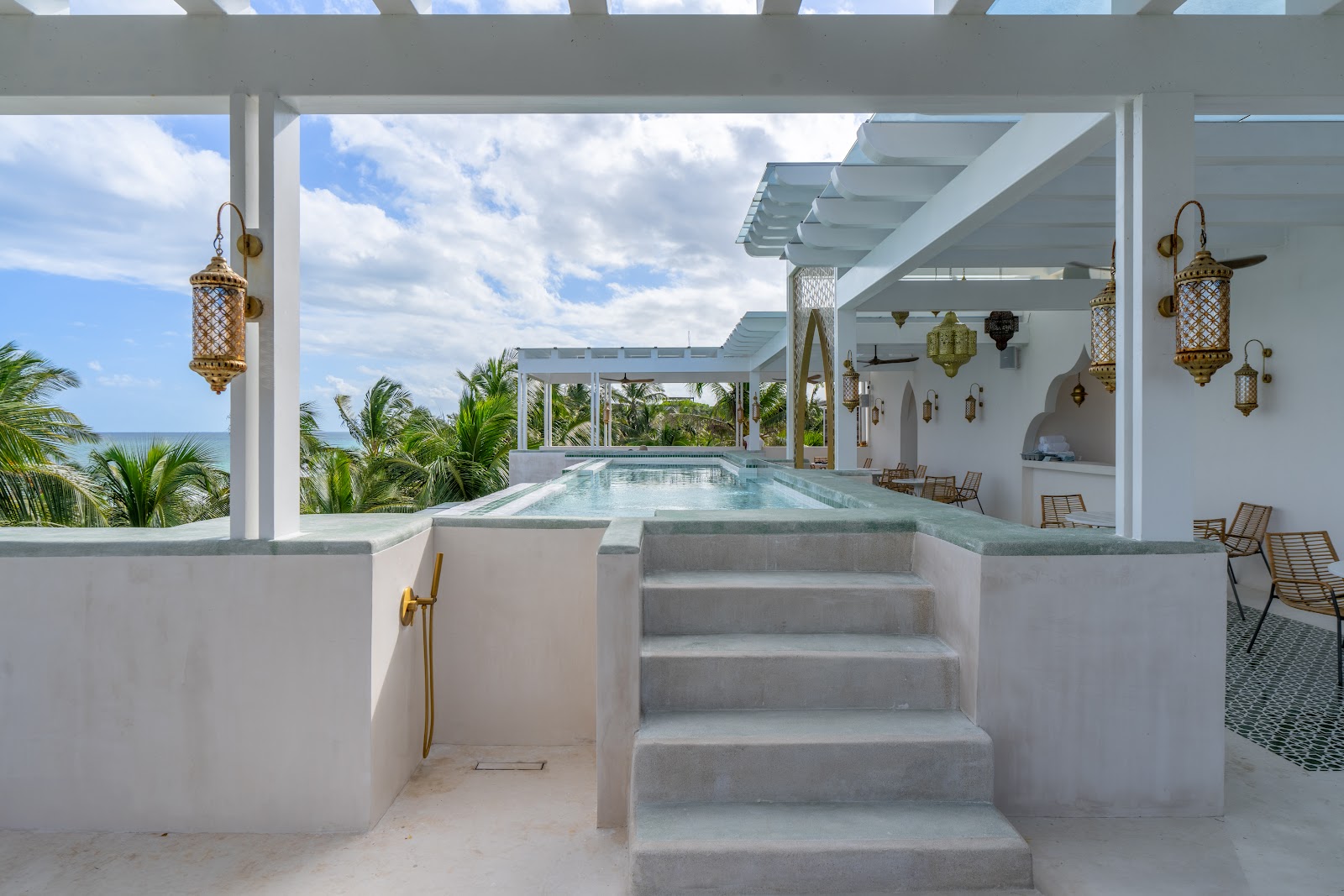 Terrace steps leading up to a pool with ocean views