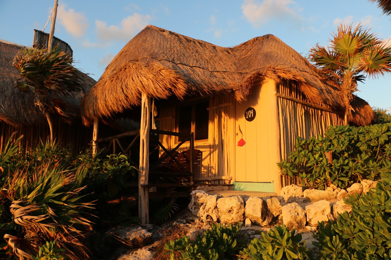 Thatched-roof casita surrounded by tropical plants