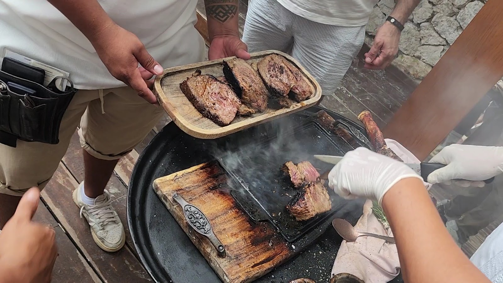 Waiter slicing steak at the table
