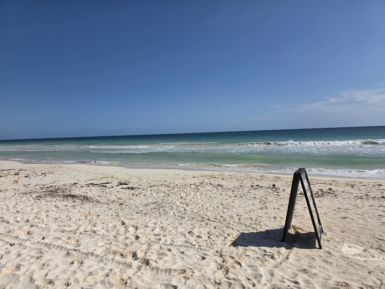 Wide sandy beach with clear blue water