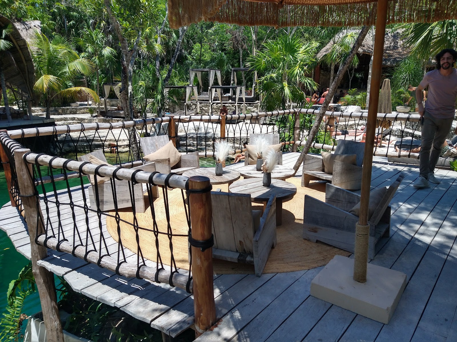 Wooden deck with railings overlooking the cenote