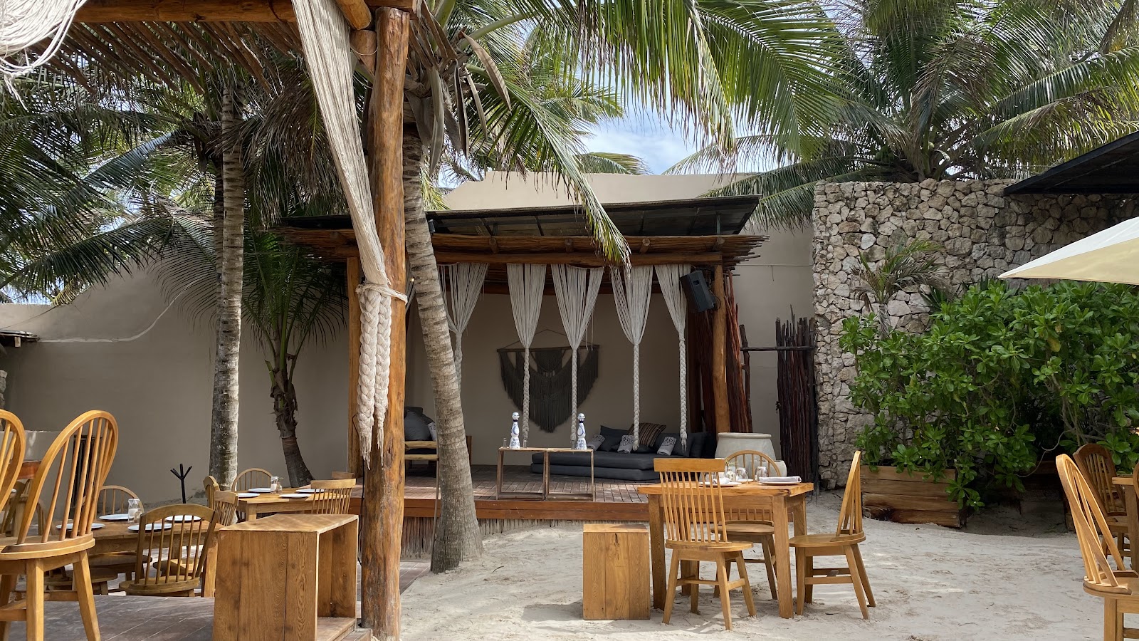Wooden furniture and plants in a shaded garden area