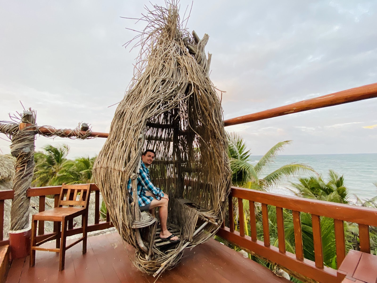 Woven nest lounge on a rooftop overlooking the sea