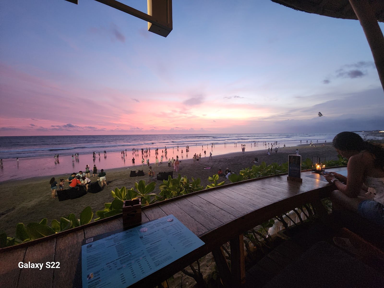 Sunset over the beachfront pool at a Bali beach club