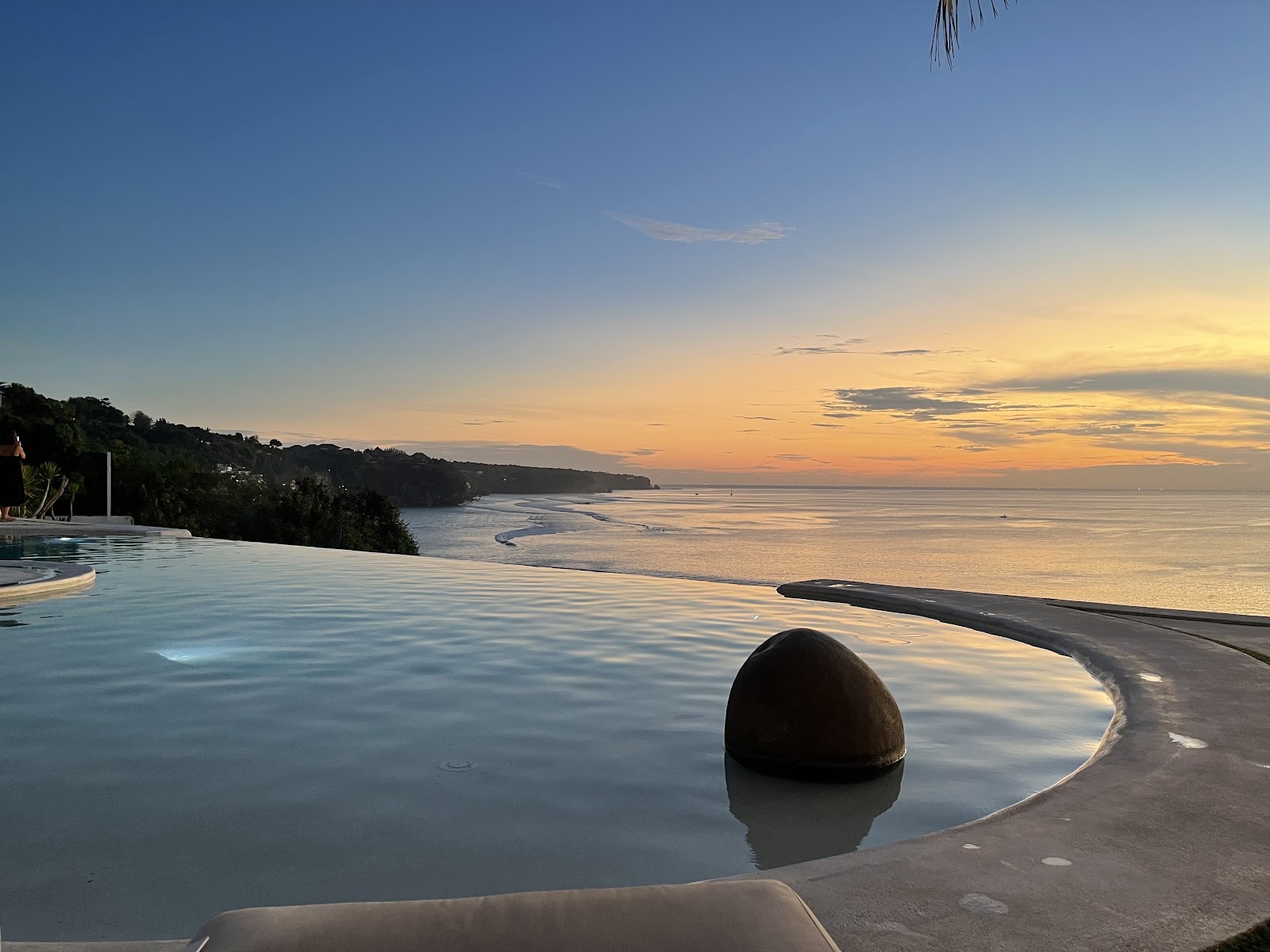 Clifftop infinity pool at sunset at El Kabron Bali