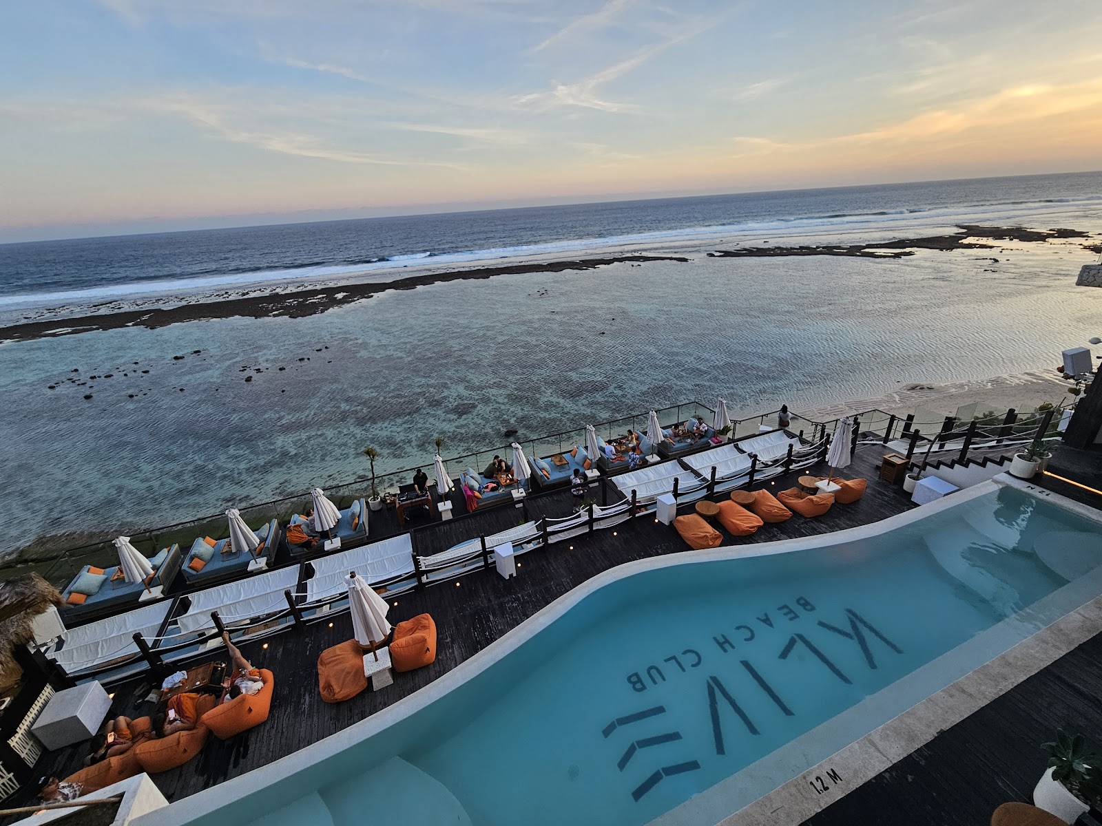Infinity pool and lounge seating with ocean views at Klive Beach Club