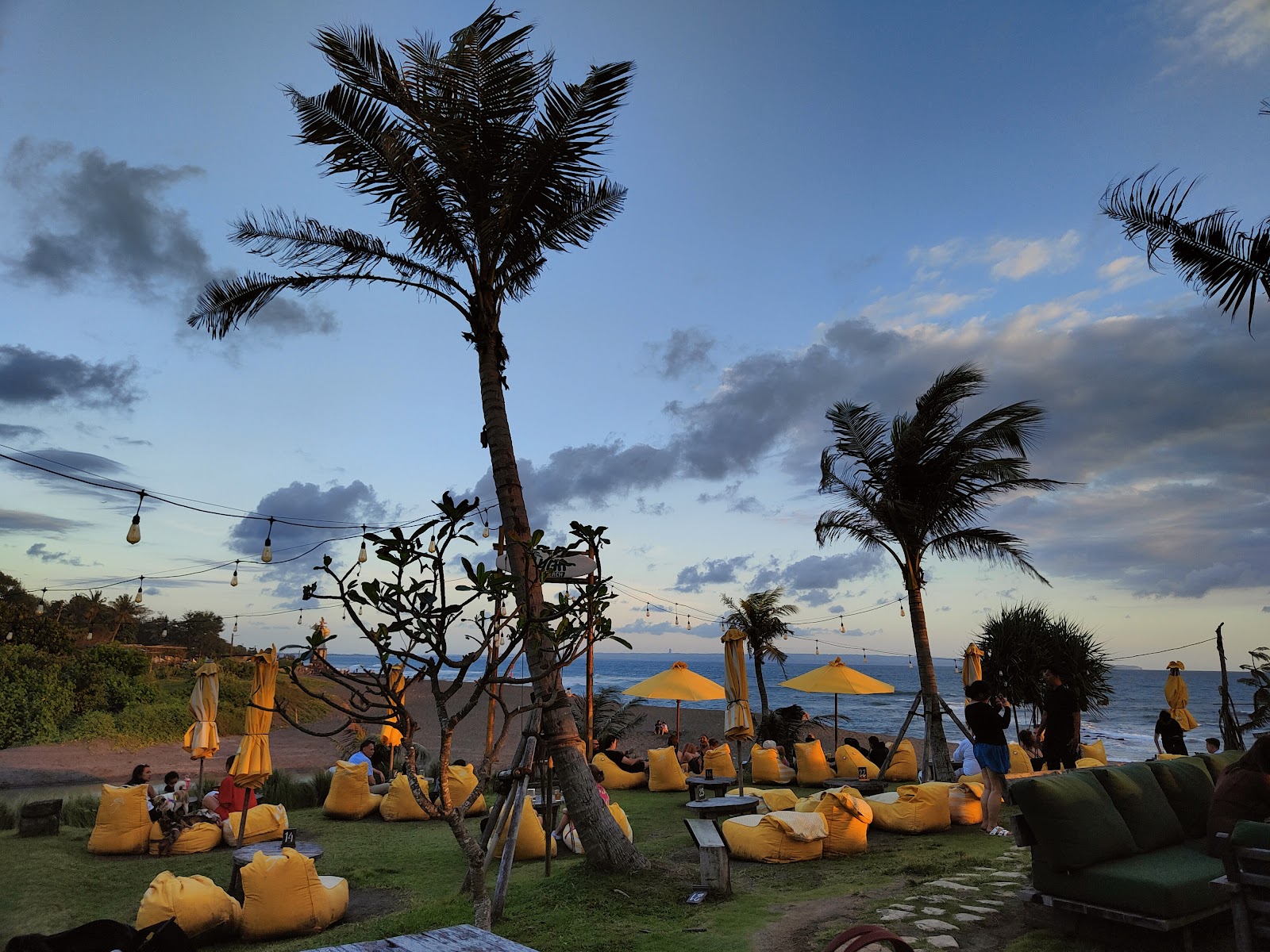 Palm trees and beanbags at Lyma Beach at sunset