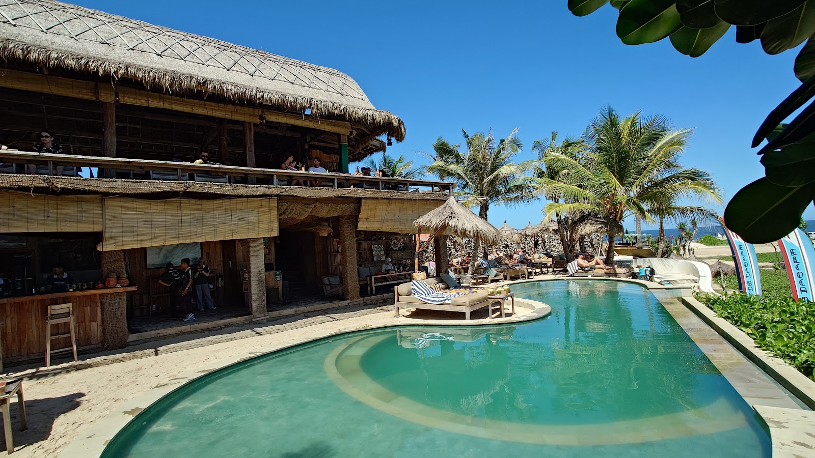 Swimming pool and thatched pavilions at Magus Warung