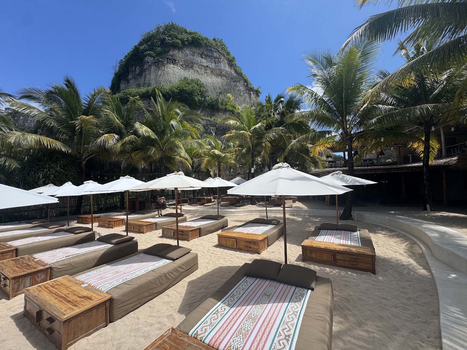 Sun loungers and umbrellas on the beach at Palmilla Bali